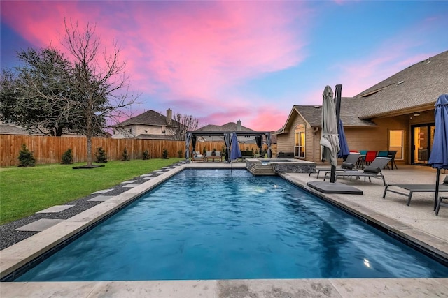 view of pool with a pool with connected hot tub, a patio, a fenced backyard, a gazebo, and a yard