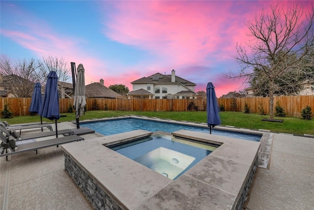 pool at dusk featuring an in ground hot tub, a lawn, a fenced backyard, and a patio