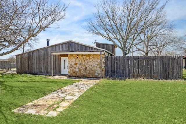 exterior space with an outbuilding and fence