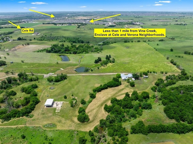 birds eye view of property with a rural view