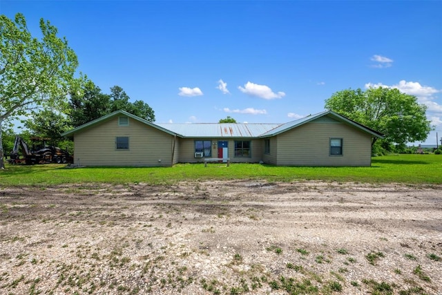 view of front facade with a front yard and metal roof