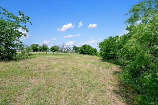 view of yard featuring a rural view and fence