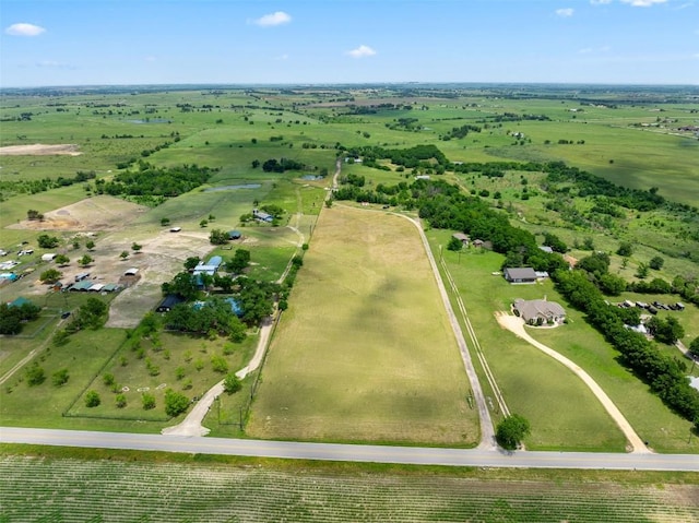 birds eye view of property with a rural view