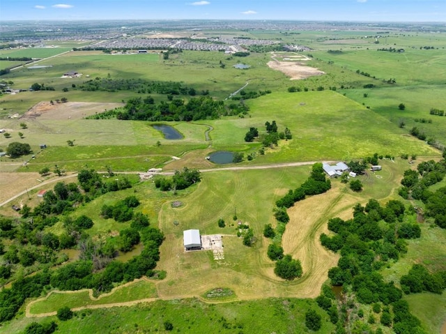 birds eye view of property with a rural view