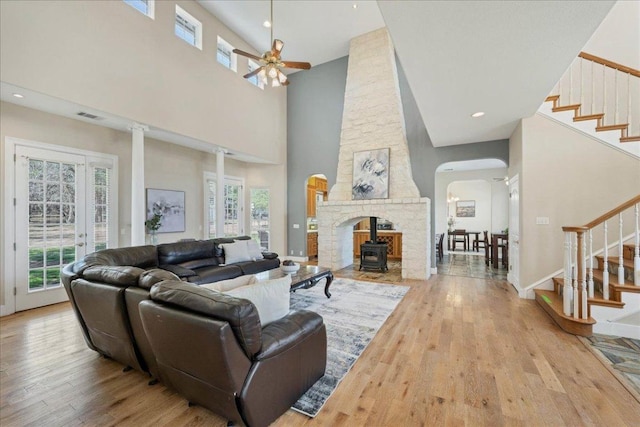 living area featuring stairway, plenty of natural light, and wood finished floors