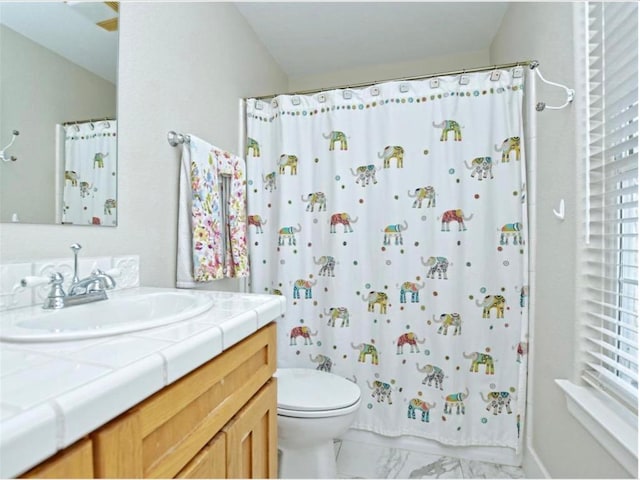 full bathroom with marble finish floor, toilet, vanity, and a shower with curtain