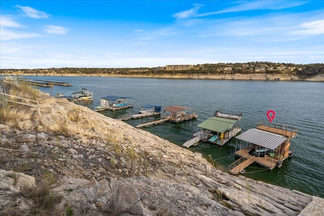 dock area with a water view and boat lift