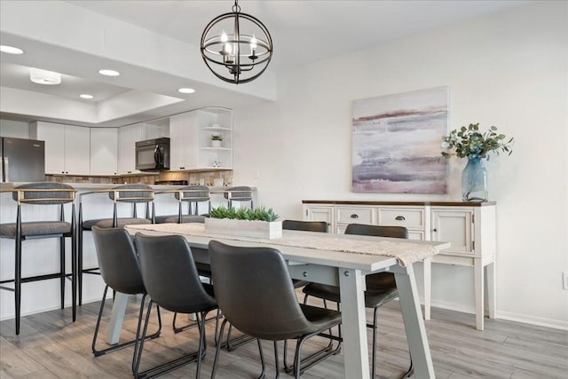 dining area with an inviting chandelier, recessed lighting, baseboards, and light wood finished floors