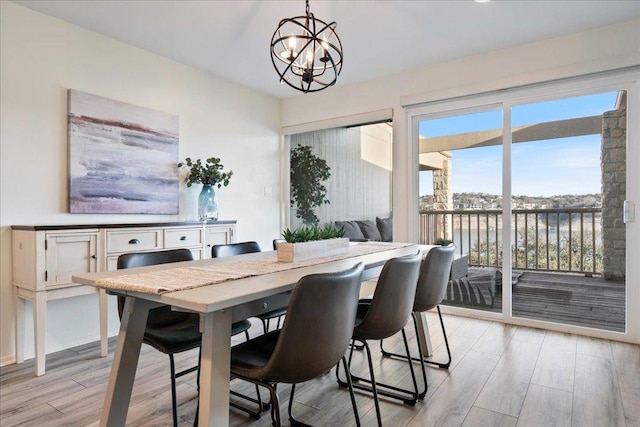 dining area with a notable chandelier and light wood-type flooring