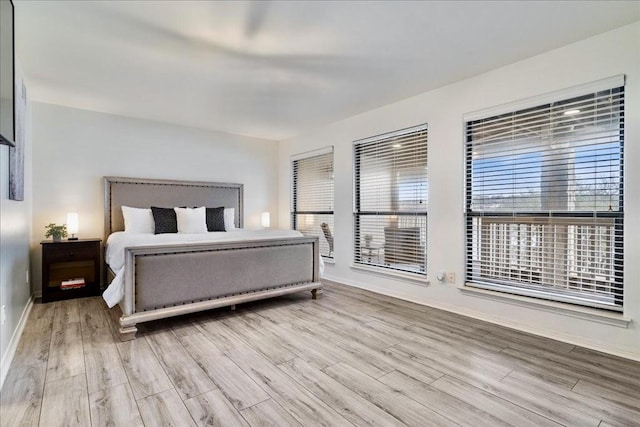 bedroom featuring baseboards and wood finished floors