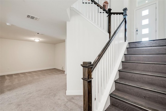 stairs with visible vents, baseboards, and carpet floors