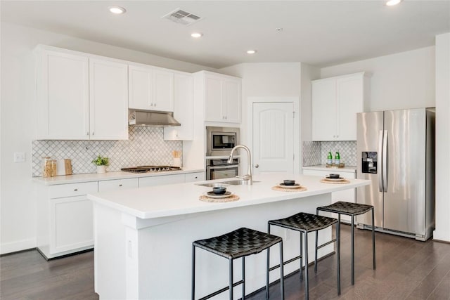 kitchen with visible vents, a sink, stainless steel appliances, white cabinets, and under cabinet range hood