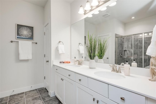 bathroom with a sink, baseboards, a stall shower, and double vanity