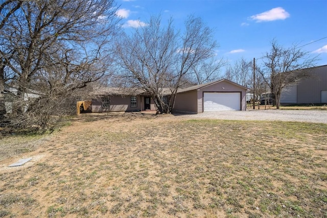 single story home with a garage and a front lawn