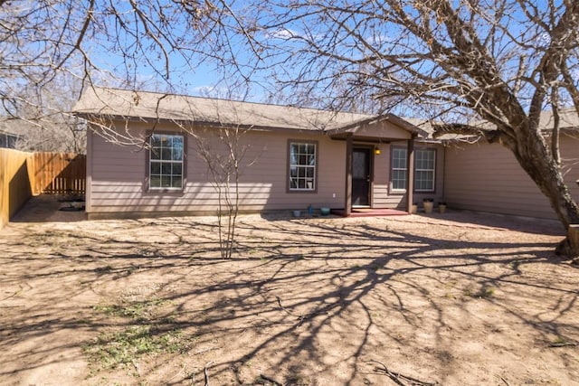 back of property featuring fence