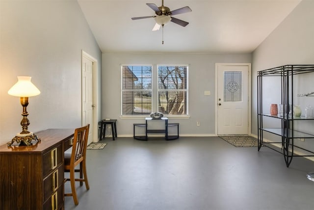 foyer featuring baseboards, concrete flooring, ceiling fan, and vaulted ceiling