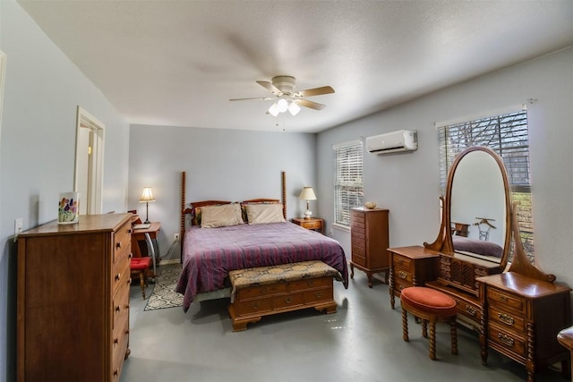 bedroom featuring ceiling fan, an AC wall unit, and finished concrete floors