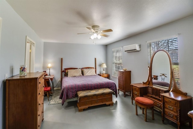 6257 River Oaks Dr, Kingsland, TX 78639 - bedroom featuring a wall mounted AC, finished concrete flooring, and a ceiling fan