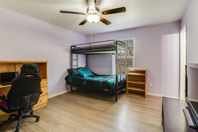 bedroom with baseboards, light wood-style floors, and a ceiling fan