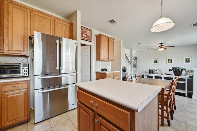 kitchen featuring visible vents, freestanding refrigerator, light tile patterned flooring, a toaster, and ceiling fan