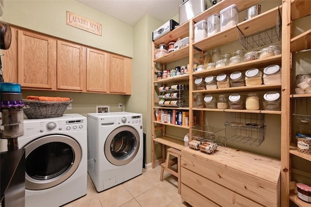 washroom with light tile patterned floors, cabinet space, a textured ceiling, and independent washer and dryer