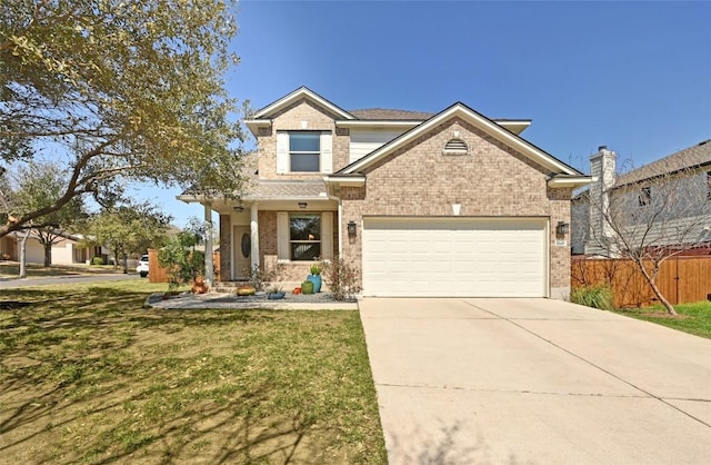 traditional home with fence, concrete driveway, a front yard, an attached garage, and brick siding