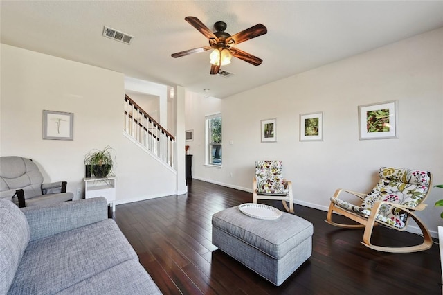 living room with hardwood / wood-style flooring, stairway, visible vents, and ceiling fan