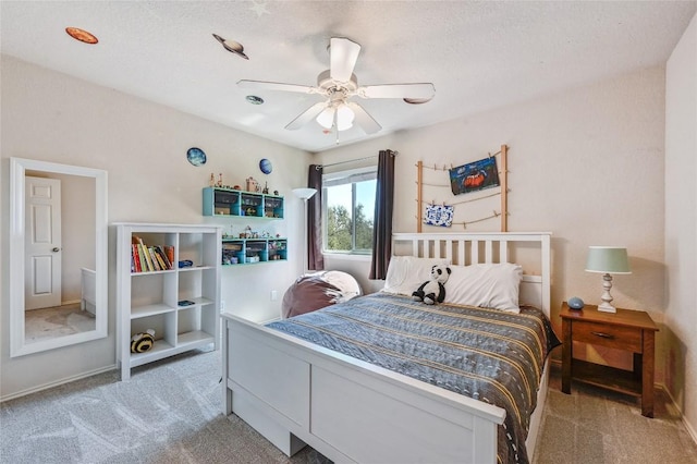 bedroom featuring light colored carpet and a ceiling fan