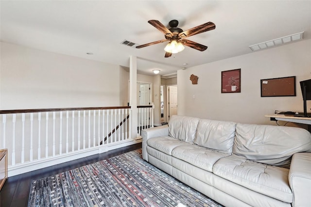 living area featuring visible vents, wood finished floors, and a ceiling fan