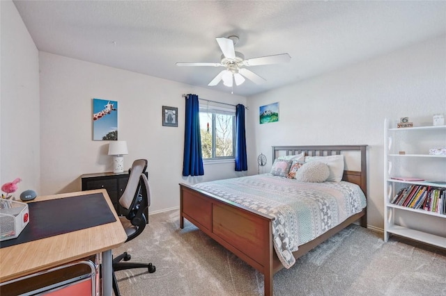 carpeted bedroom with a ceiling fan and baseboards