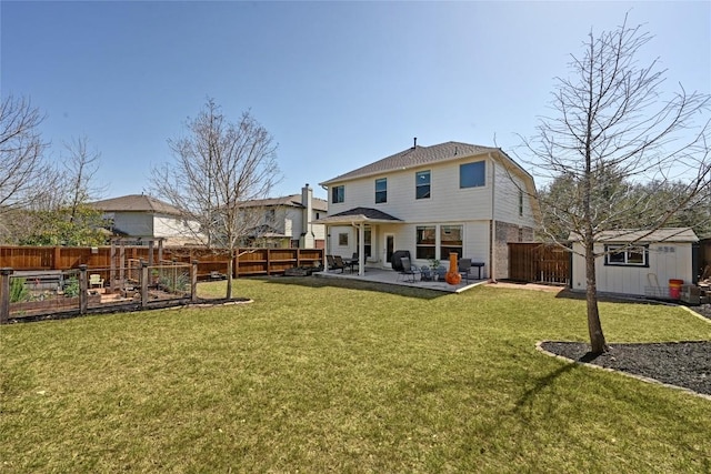 back of property with a patio, a fenced backyard, a shed, a yard, and an outdoor structure