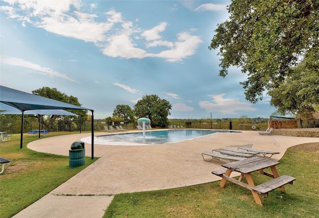 community pool featuring a patio, a yard, and a fenced backyard