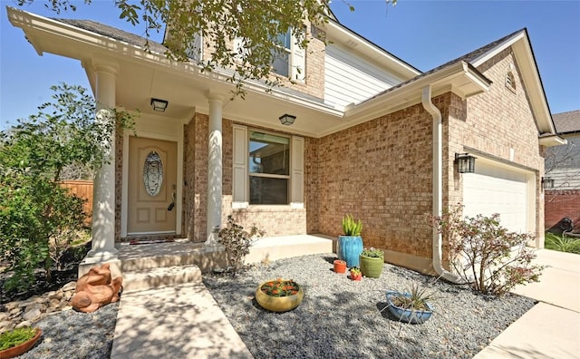 view of front of house with driveway, brick siding, and an attached garage