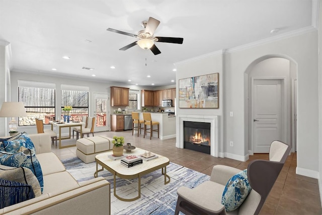 living area featuring crown molding, light tile patterned floors, recessed lighting, and baseboards