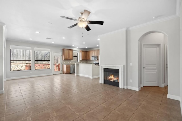 unfurnished living room featuring baseboards, ceiling fan, crown molding, and tile patterned flooring