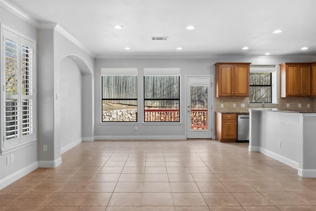 kitchen featuring dishwasher, decorative backsplash, light tile patterned floors, and brown cabinetry