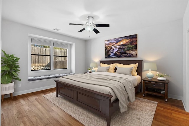 bedroom with visible vents, ceiling fan, light wood-type flooring, and baseboards