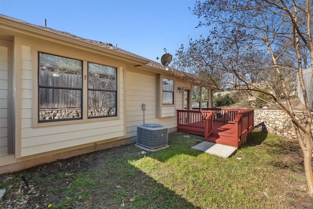 exterior space featuring a lawn and central AC