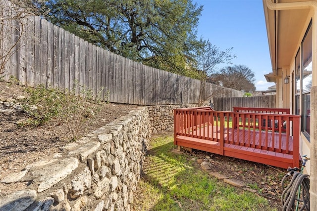 view of yard with a fenced backyard and a wooden deck