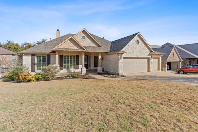 view of front of home featuring a front yard, a chimney, concrete driveway, a garage, and stone siding