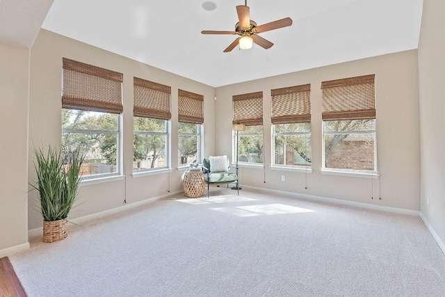 unfurnished sunroom featuring a ceiling fan