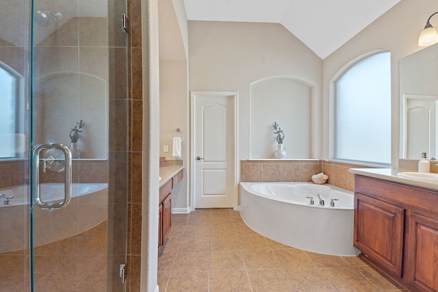 bathroom with a shower stall, vanity, and lofted ceiling