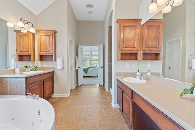 ensuite bathroom with tile patterned floors, visible vents, a jetted tub, connected bathroom, and baseboards