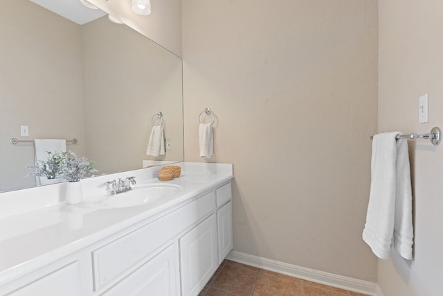 bathroom featuring tile patterned floors, baseboards, and vanity