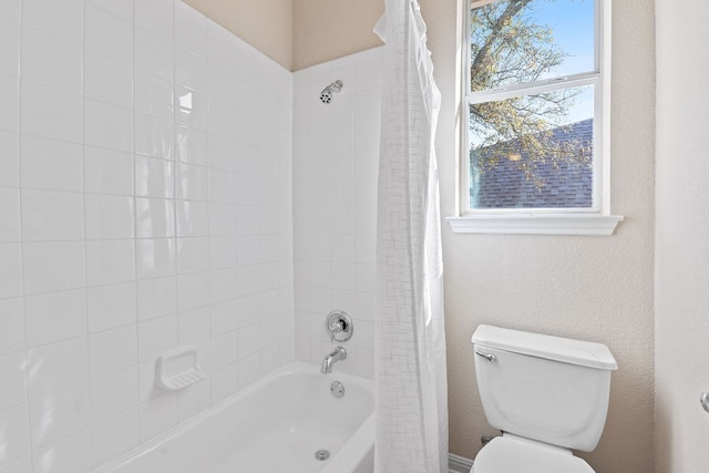 bathroom with shower / tub combo and toilet