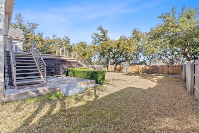 view of yard with a patio, stairway, and a fenced backyard