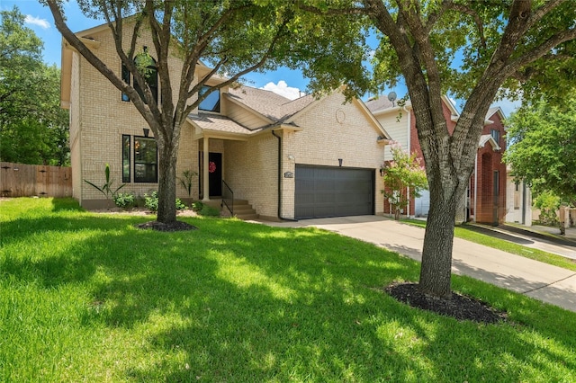 traditional home with fence, an attached garage, concrete driveway, a front lawn, and brick siding