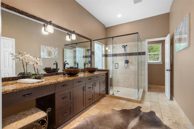 bathroom with a shower stall and vanity