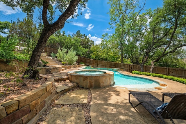 view of pool with a patio, a pool with connected hot tub, and a fenced backyard