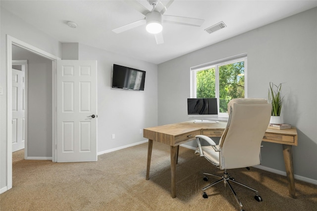 home office with visible vents, baseboards, a ceiling fan, and carpet flooring